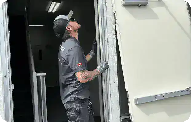 Homepage 27 Doorway Dynamics technician checking alignment of entry door for commercial door repairs Calgary.