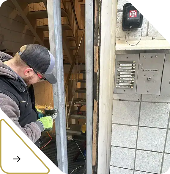 Homepage 25 Skilled technician repairing steel frame as part of commercial door repairs Calgary service.